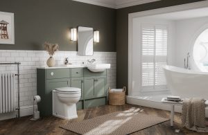 Large bathroom with wood-effect flooring, a freestanding bath area, and New England furniture and styling